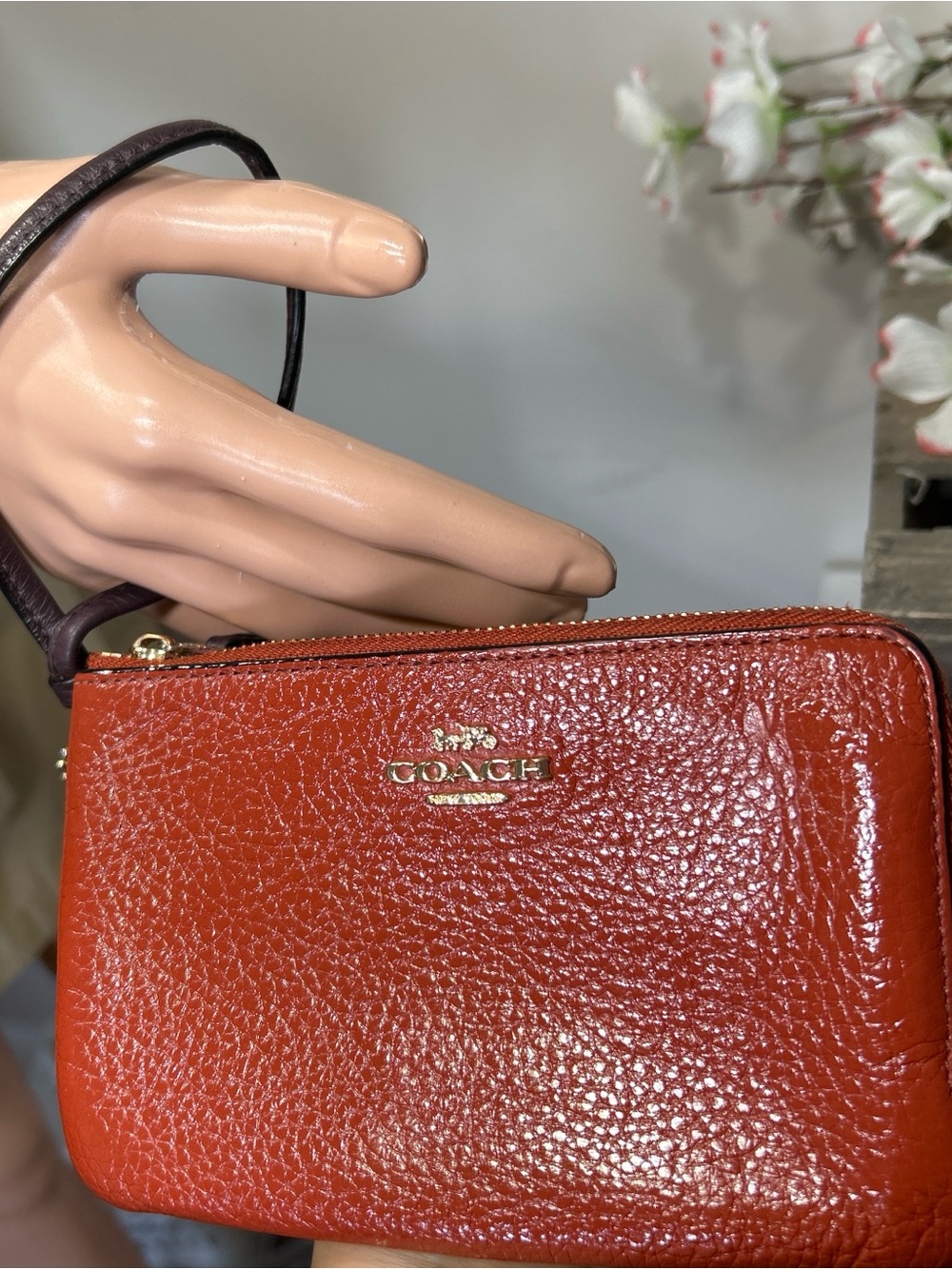 COACH Pebbled Leather Wristlet in Burnt Orange with Dark Brown Strap